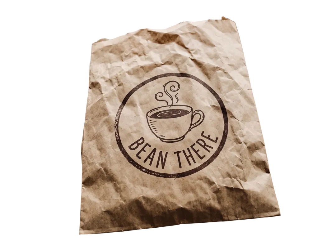 Crumpled paper bag with a round coffee shop logo, background removed (transparent PNG)