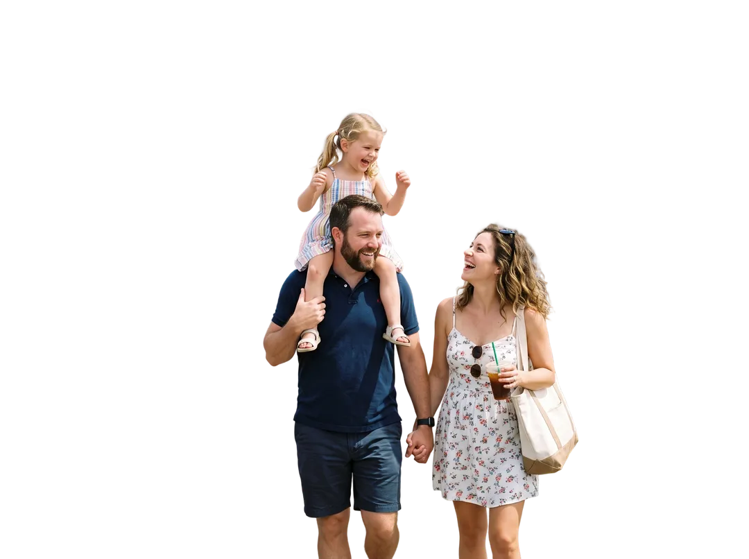 Family of three on a seaside boardwalk, background removed (transparent PNG)