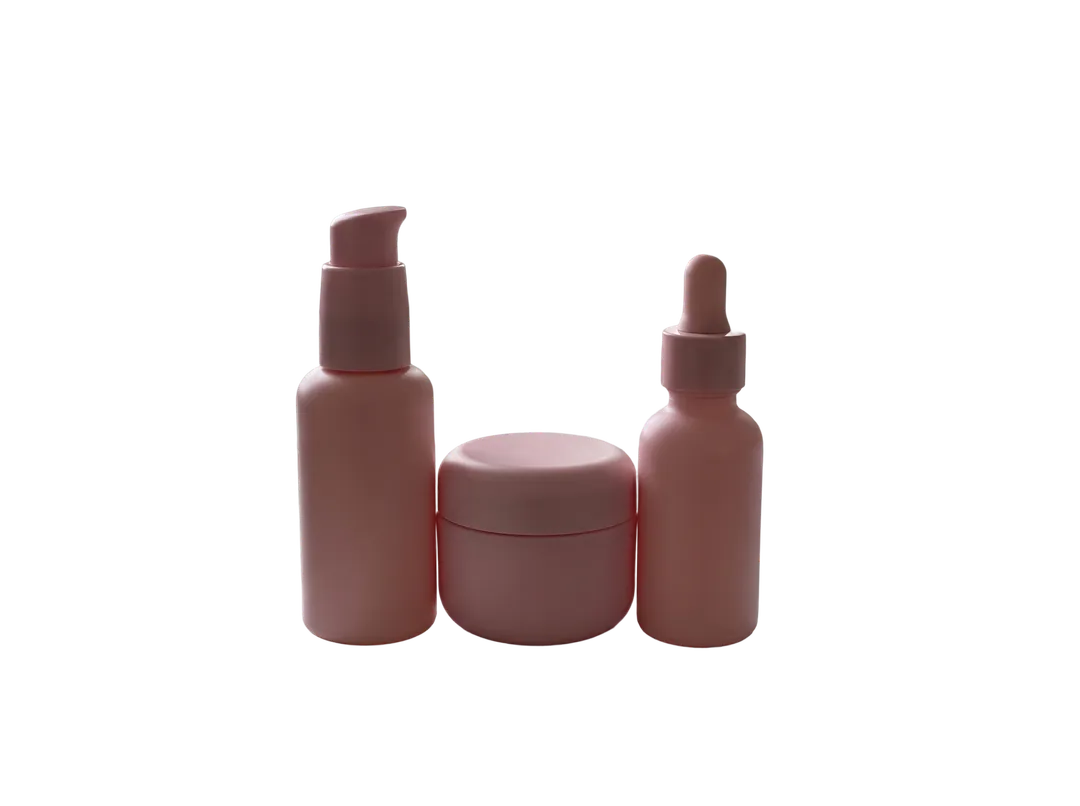 Set of three pink skincare bottles, background removed (transparent PNG)