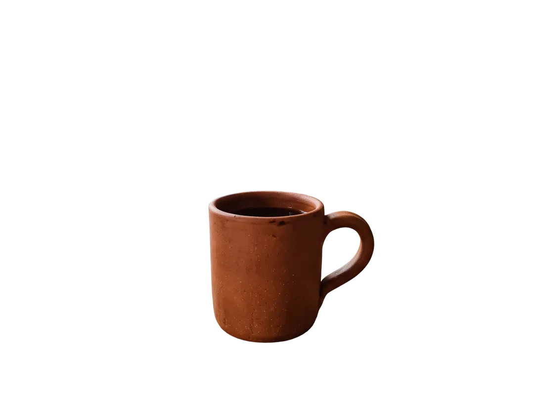 Terracotta coffee mug on a kitchen counter, background removed (transparent PNG)