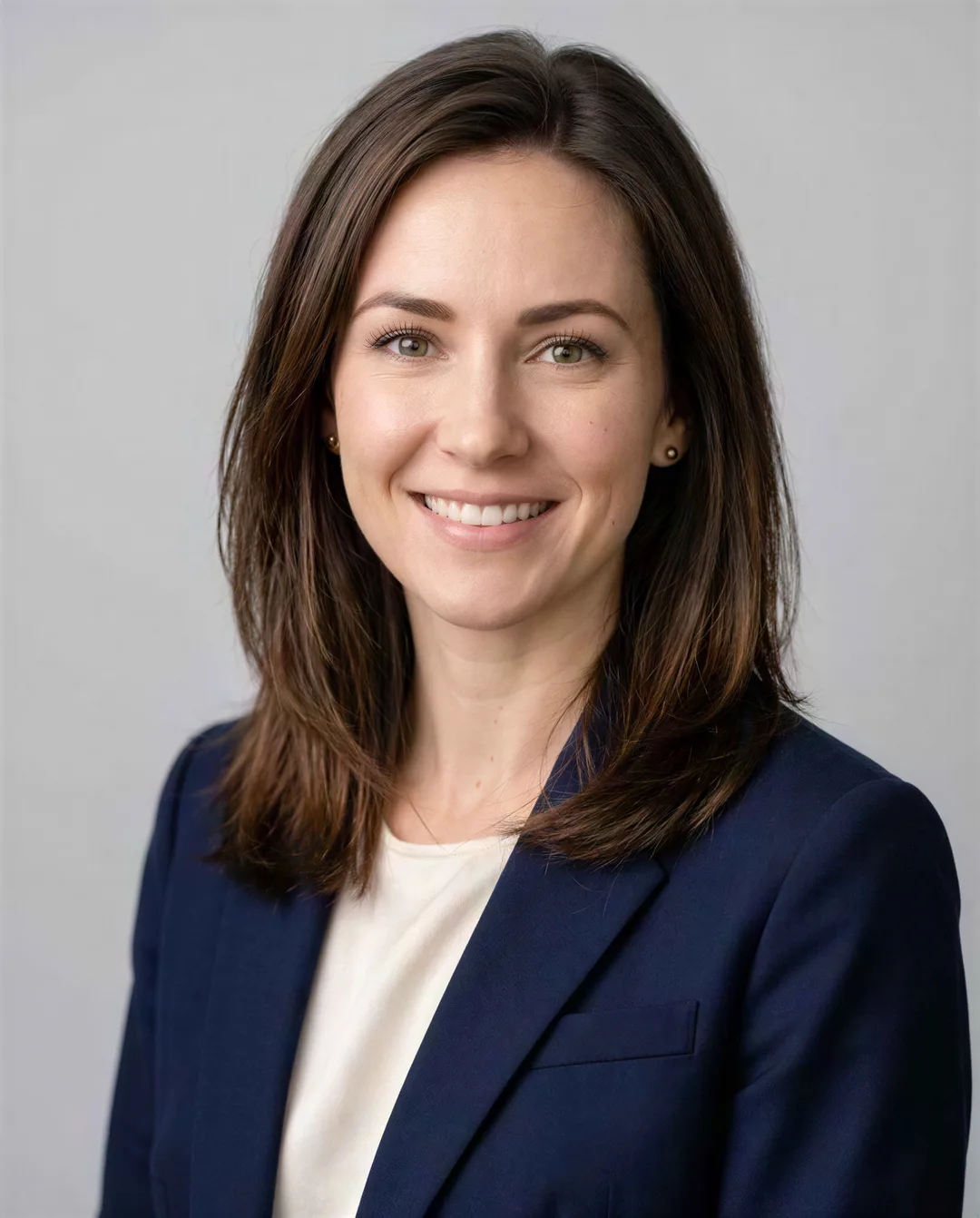 Business headshot of a woman in a navy blazer, upscaled 4× with AI