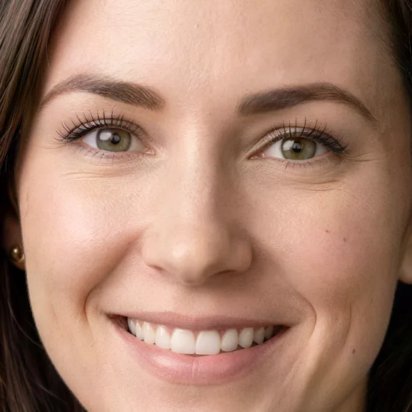 Business headshot of a woman in a navy blazer, upscaled 4× with AI, 100% crop