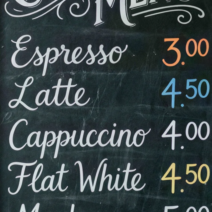Chalkboard coffee menu with prices on a brick wall, upscaled 4× with AI, 100% crop