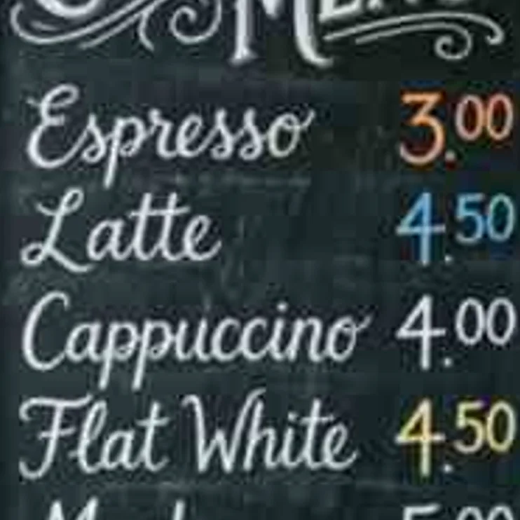 Chalkboard coffee menu with prices on a brick wall, low-resolution original, 100% crop