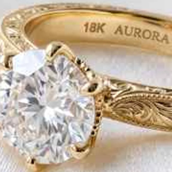 Gold diamond ring with hand engraving on white silk, low-resolution original, 100% crop