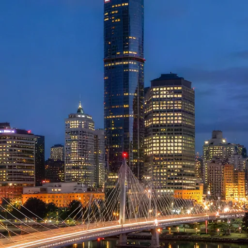 City skyline across a river at blue hour, upscaled 4× with AI, 100% crop