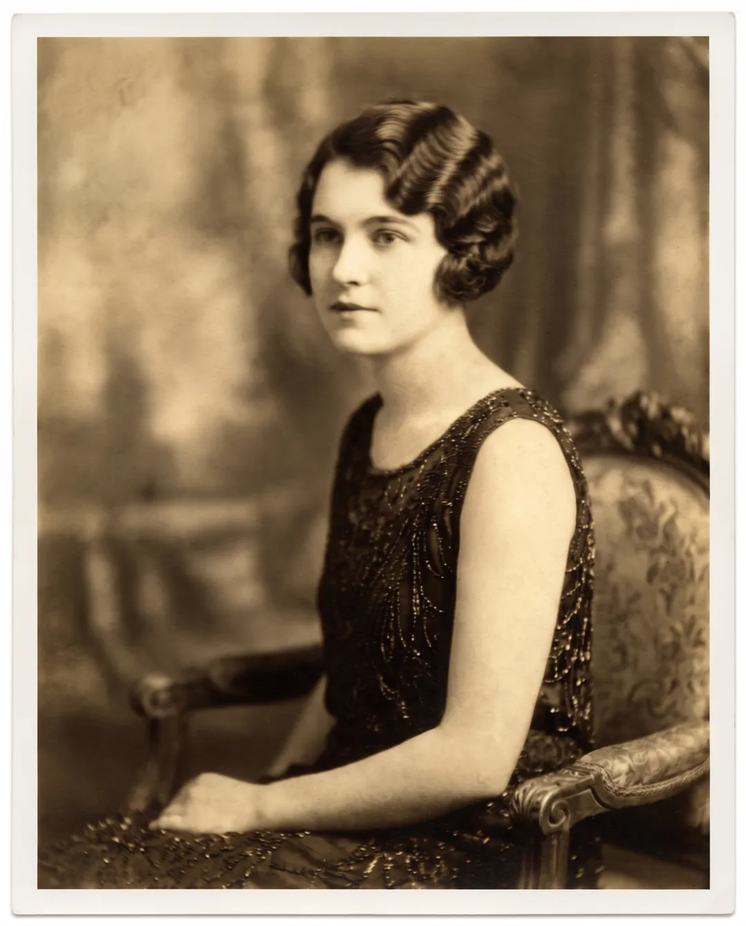 Restored photo of a 1920s studio portrait of a young woman with finger-waved hair