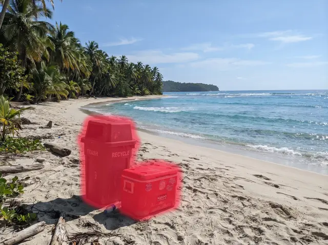 Tropical beach with turquoise water and palm trees, trash bin and cooler painted over with the red brush